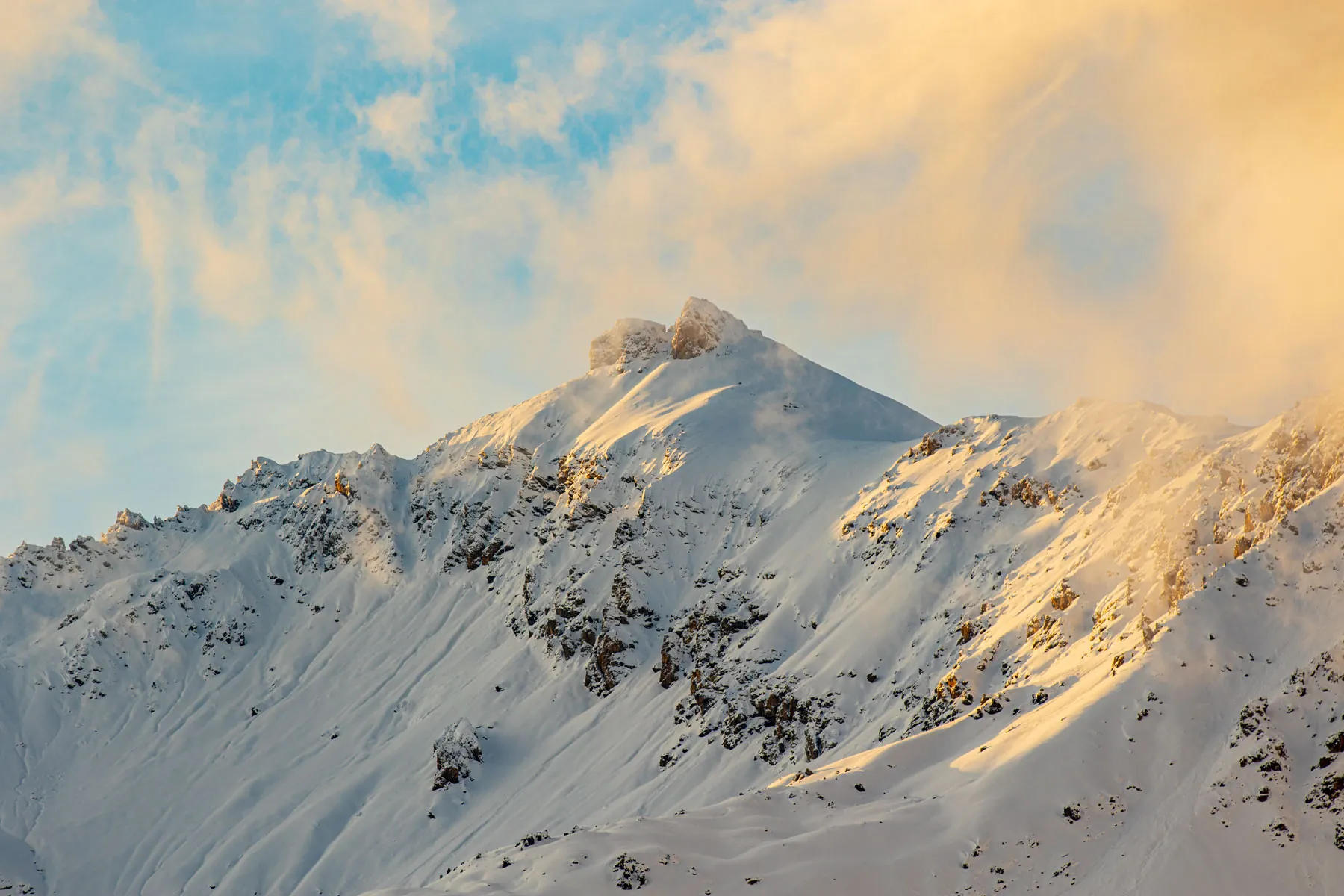 The peaks of Livigno lit by the sun at dawn